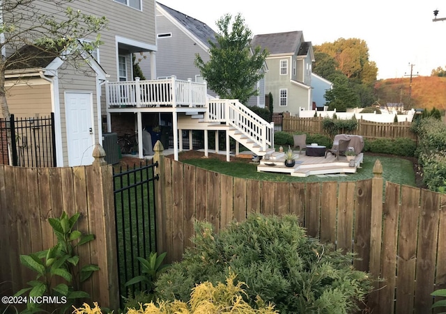 exterior space featuring a wooden deck, an outdoor hangout area, and central AC unit