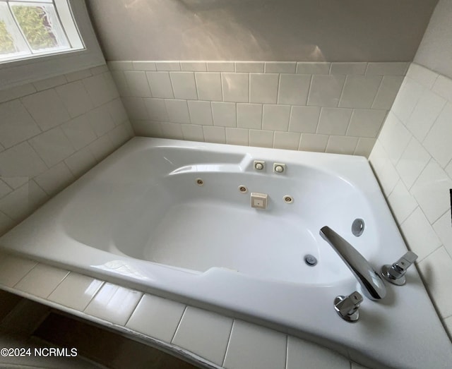 bathroom featuring a relaxing tiled tub