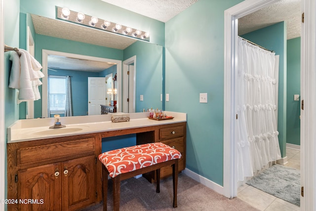 bathroom with vanity, a textured ceiling, and tile patterned floors