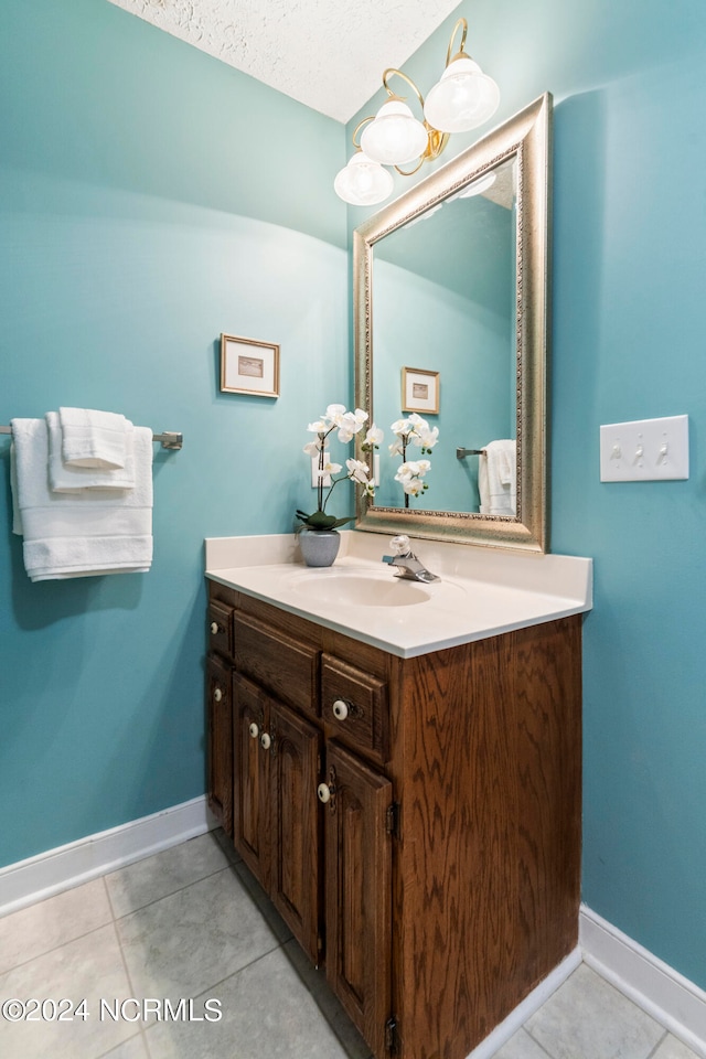 bathroom with vanity, a textured ceiling, and tile patterned floors