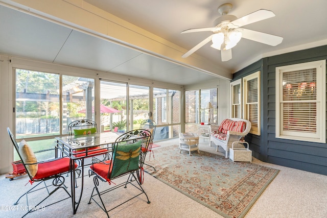 sunroom with ceiling fan and lofted ceiling