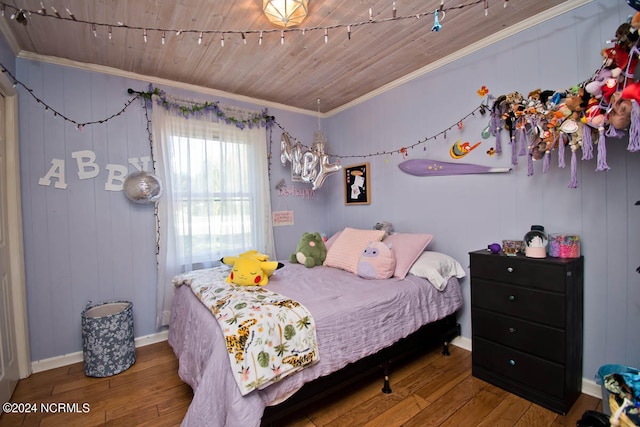 bedroom with hardwood / wood-style flooring, wood walls, ornamental molding, and wooden ceiling