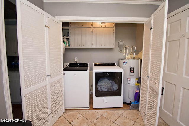 laundry area with water heater, light tile patterned flooring, and washing machine and clothes dryer