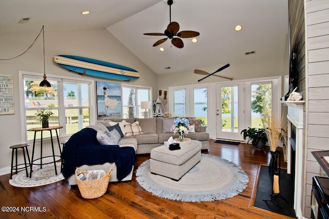 living room featuring dark wood-type flooring, ceiling fan, and high vaulted ceiling