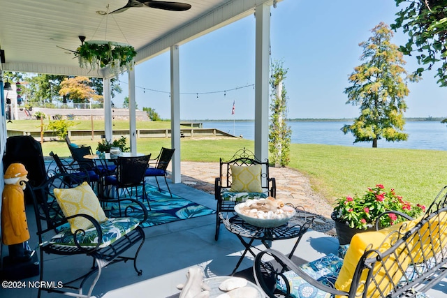 view of patio featuring ceiling fan and a water view