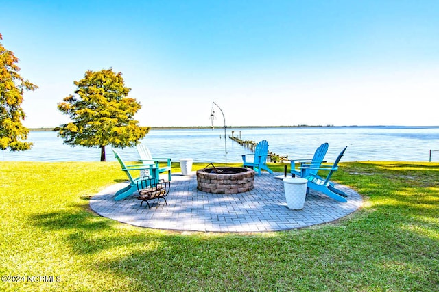 view of yard featuring a fire pit, a water view, and a patio area