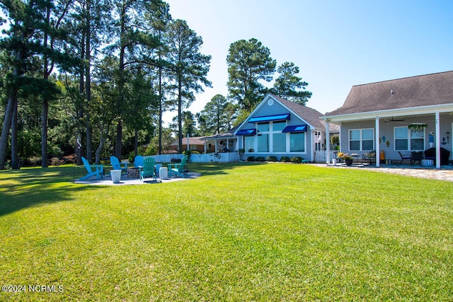 view of yard with ceiling fan and a patio area