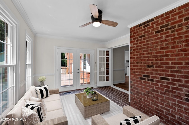 sunroom / solarium featuring ceiling fan and french doors