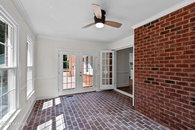 unfurnished sunroom with ceiling fan and french doors