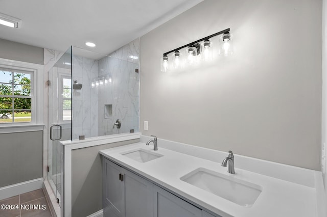 bathroom with vanity, a shower with shower door, and tile patterned flooring