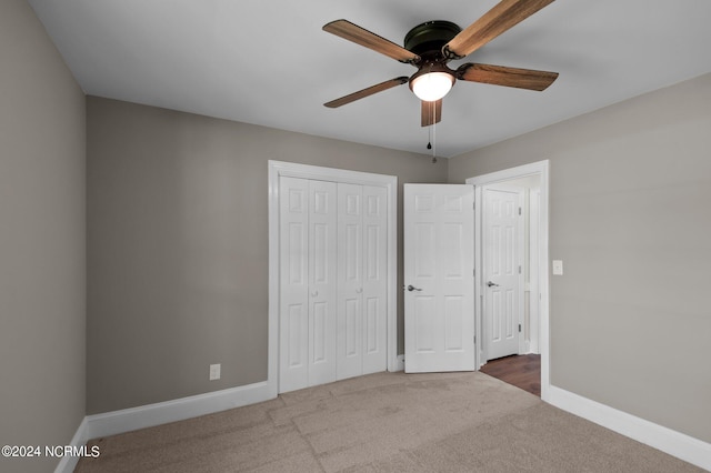 unfurnished bedroom with carpet floors, ceiling fan, and a closet