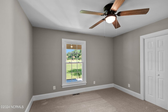 carpeted empty room with ceiling fan