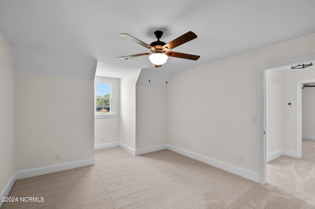 unfurnished room featuring light carpet and ceiling fan