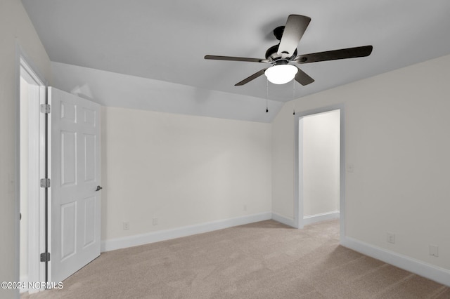 unfurnished bedroom with vaulted ceiling, light carpet, and ceiling fan