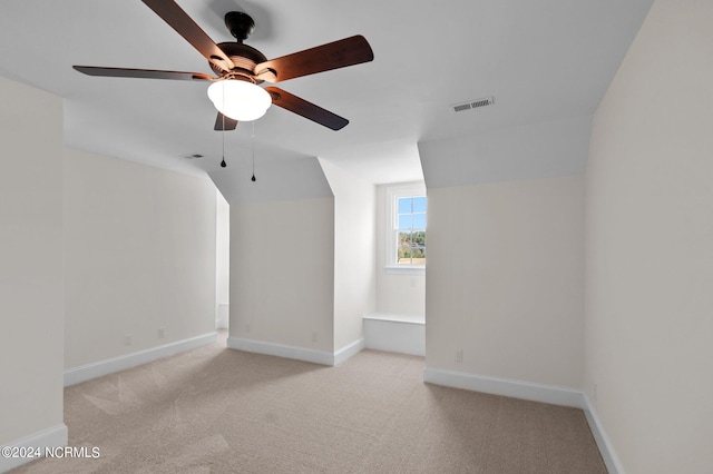 additional living space featuring vaulted ceiling, ceiling fan, and light colored carpet