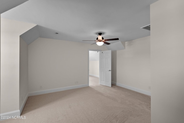 spare room with ceiling fan and light colored carpet