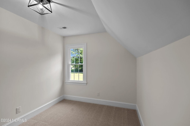 additional living space with carpet floors and lofted ceiling