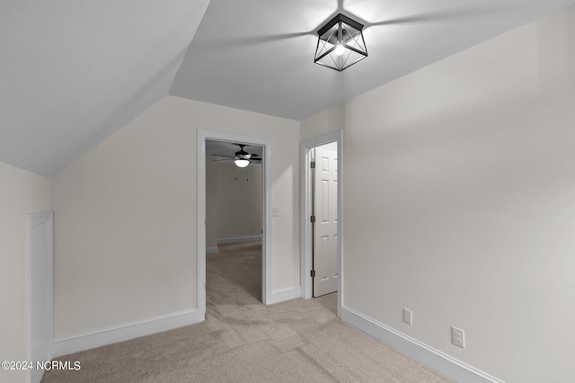 bonus room featuring ceiling fan, light carpet, and vaulted ceiling