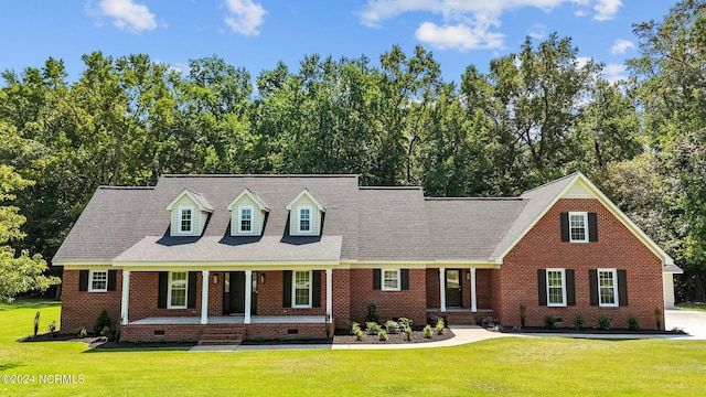 cape cod home with a front yard