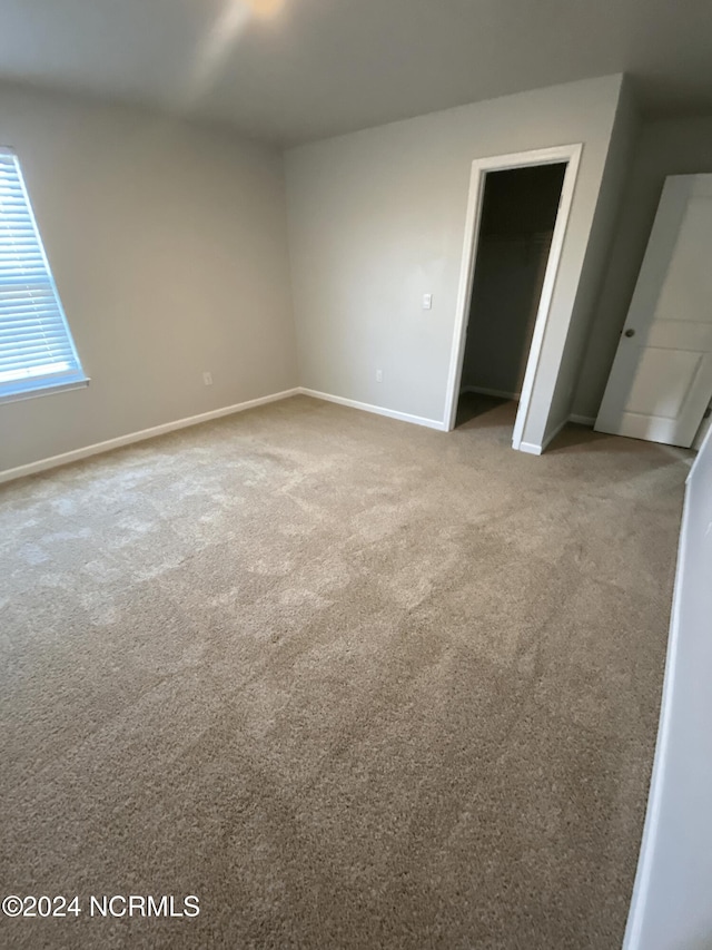 unfurnished room featuring light colored carpet