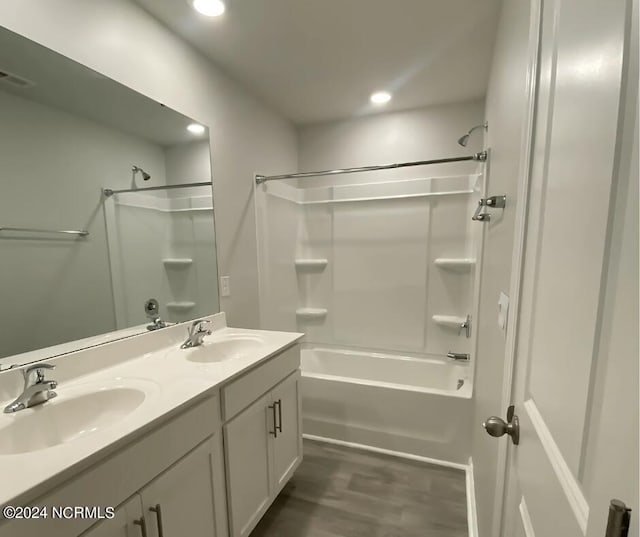 bathroom with vanity, hardwood / wood-style flooring, and bathing tub / shower combination