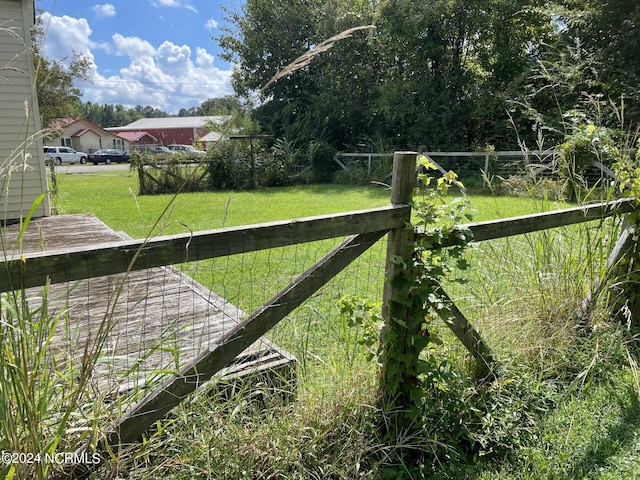 view of gate with a yard