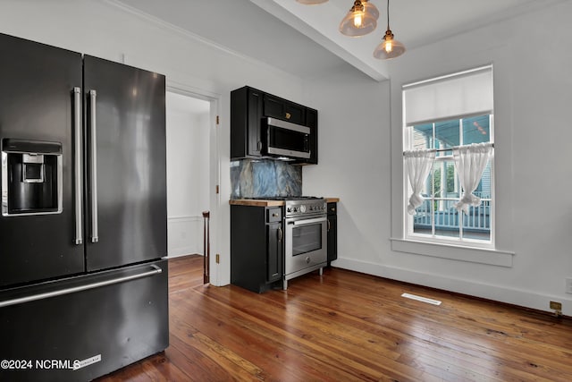 kitchen with dark hardwood / wood-style flooring, decorative light fixtures, backsplash, and high end appliances