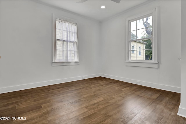 spare room with crown molding, ceiling fan, and dark hardwood / wood-style flooring