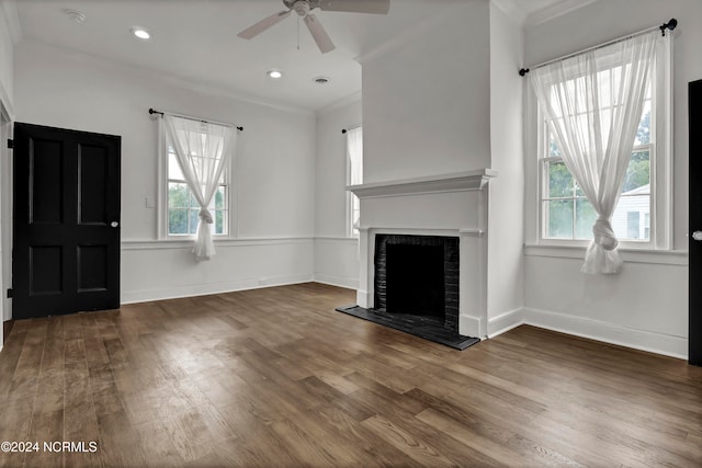 unfurnished living room with crown molding, dark hardwood / wood-style floors, and ceiling fan