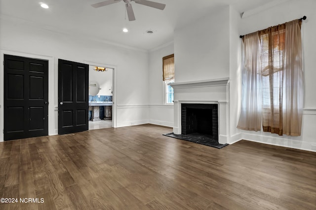 unfurnished living room with ceiling fan, wood-type flooring, ornamental molding, and a fireplace