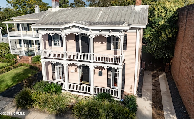 view of front of property with covered porch and a balcony