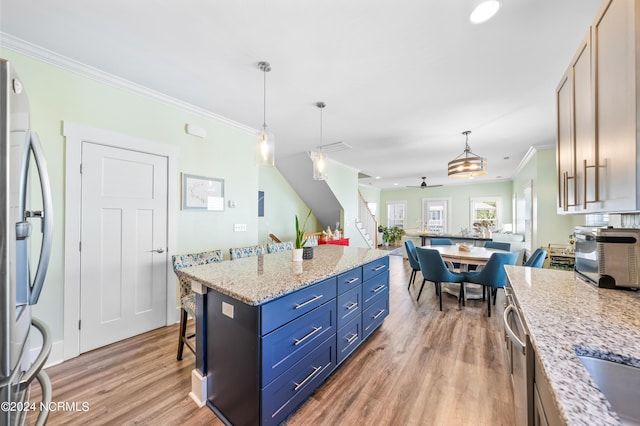 1305 Mackerel Ln Unit 1, Carolina Beach, NC 28428 - kitchen featuring ornamental molding, light wood-type flooring, appliances with stainless steel finishes, pendant lighting, and open floor plan