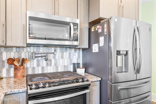 1305 Mackerel Ln Unit 1, Carolina Beach, NC 28428 - kitchen featuring stainless steel appliances, decorative backsplash, and light stone countertops