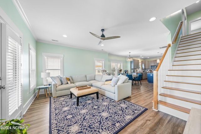 1305 Mackerel Ln Unit 1, Carolina Beach, NC 28428 - living room featuring crown molding, a ceiling fan, stairway, recessed lighting, and wood finished floors