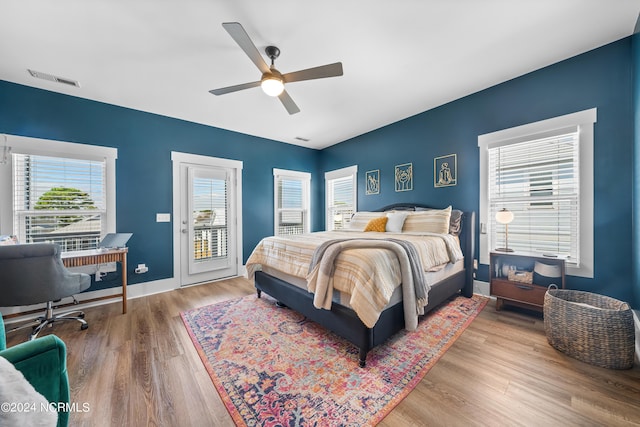 1305 Mackerel Ln Unit 1, Carolina Beach, NC 28428 - bedroom featuring access to outside, wood finished floors, and a ceiling fan