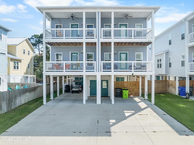1305 Mackerel Ln Unit 1, Carolina Beach, NC 28428 - beach home with a balcony, a ceiling fan, concrete driveway, and a carport