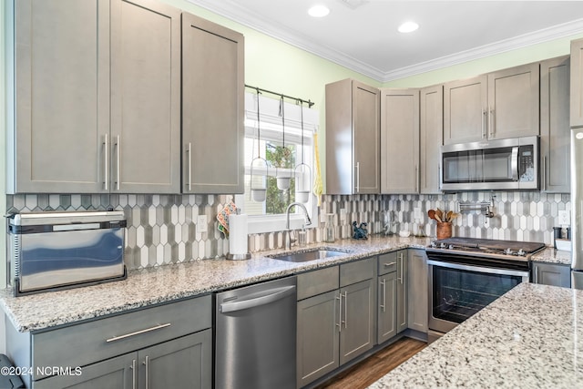1305 Mackerel Ln Unit 1, Carolina Beach, NC 28428 - kitchen featuring appliances with stainless steel finishes, gray cabinets, light stone counters, tasteful backsplash, and crown molding