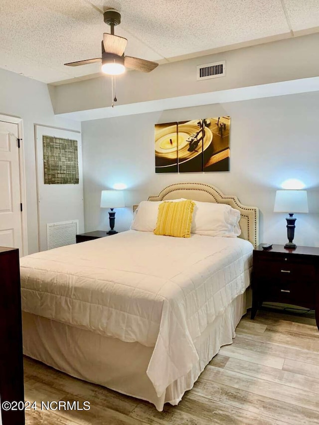 bedroom with light hardwood / wood-style flooring and ceiling fan