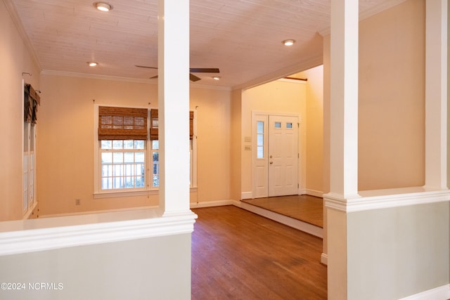 entrance foyer with hardwood / wood-style floors, ornate columns, ceiling fan, and crown molding