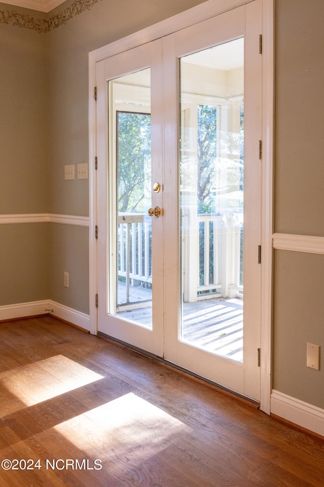 doorway with french doors and hardwood / wood-style flooring