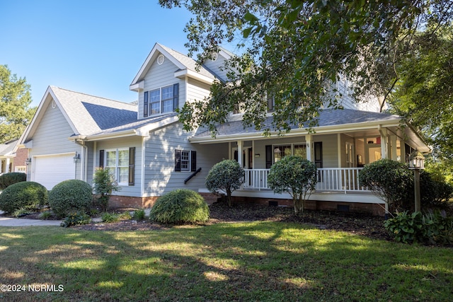 view of front of home with covered porch, a front yard, and a garage