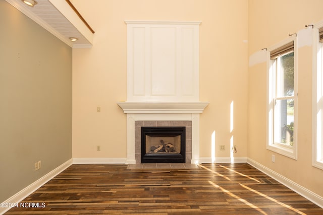 unfurnished living room with a fireplace and dark wood-type flooring