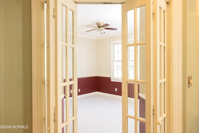 spare room featuring carpet flooring, ornamental molding, and french doors