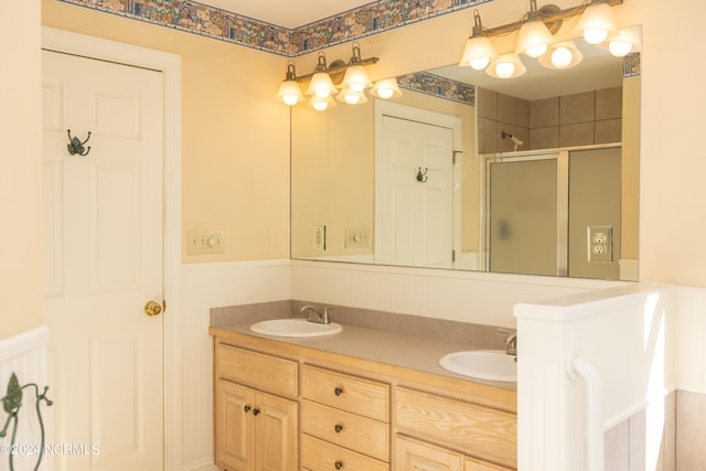 bathroom featuring vanity and a shower with door