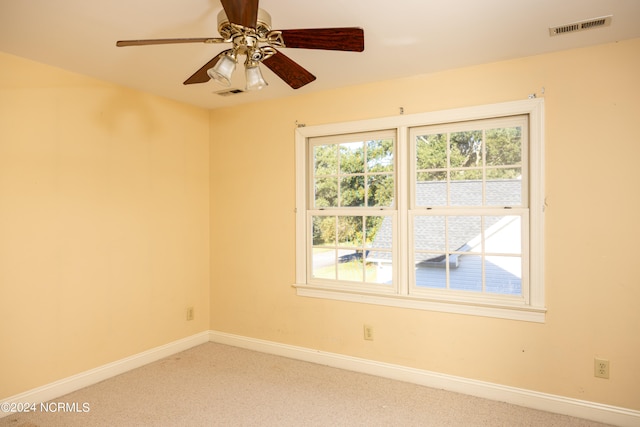 carpeted empty room featuring ceiling fan