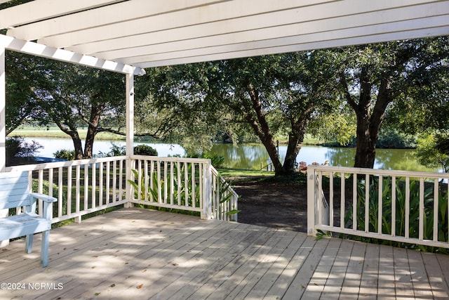 wooden terrace with a pergola and a water view