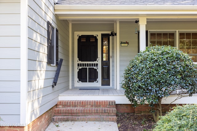 view of exterior entry featuring a porch