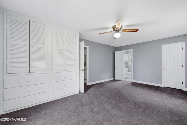 unfurnished bedroom with two closets, dark colored carpet, and ceiling fan