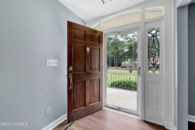 entrance foyer featuring lofted ceiling and hardwood / wood-style flooring