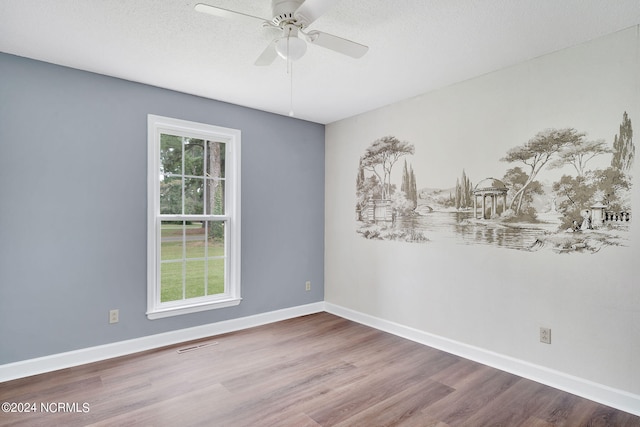 unfurnished room featuring ceiling fan, hardwood / wood-style flooring, and a textured ceiling